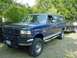 1995 Ford C-350 (Centurion Conversions) - A blue Ford SUV, possibly a 1992 model, is parked outdoors with a trailer attached.
