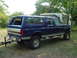 1995 Ford C-350 (Centurion Conversions) - This extended cab pickup truck features a camper shell, extending its utility for hauling or camping.