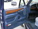 1995 Ford C-350 (Centurion Conversions) - View of the driver's side interior door panel and dashboard of a blue vehicle.