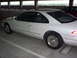 1994 Lincoln Mark VIII - Side view of a white 1994 Lincoln Mark VIII parked in a garage. A second car is visible in the background.