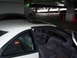 1994 Lincoln Mark VIII - Interior view of a white coupe parked in a dimly lit garage with other vehicles present.