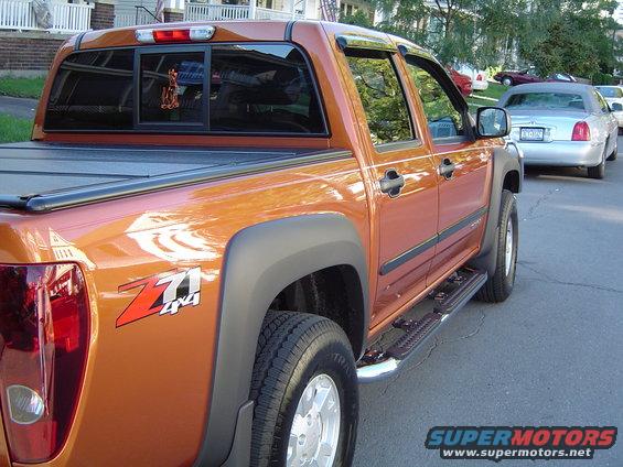 Orange pickup truck with Z71 4x4 badging, parked on a street