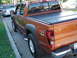 2004 Chevrolet Colorado - A 2004 Chevrolet Colorado LS pickup truck is parked on the street, showing its rear quarter panel and bed cover.