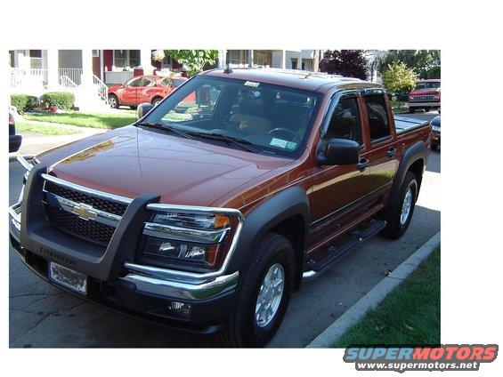 Brown 2004 Chevrolet Colorado pickup truck, 3/4 front view, with chrome grille guard