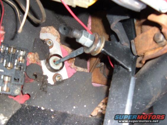 Clutch pedal linkage mechanism and fuse box in a vehicle interior