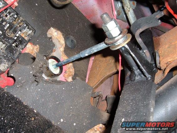 Interior clutch linkage with rust and frayed carpet