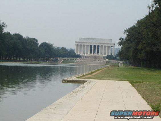 Lincoln Memorial building with reflecting pool in foreground, trees on sides