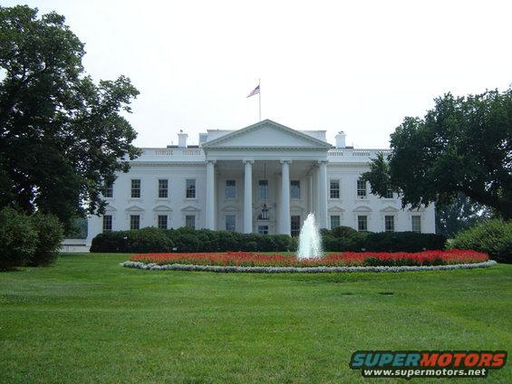 White House with a fountain in front and trees on the sides