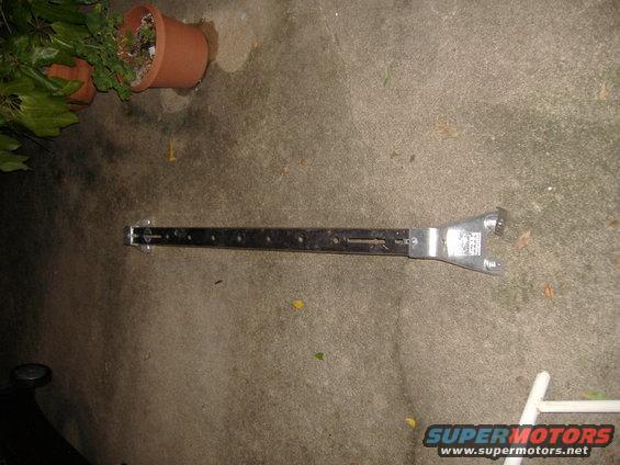 Metal bracket with holes and wrench-like end, Supermotors.net logo visible