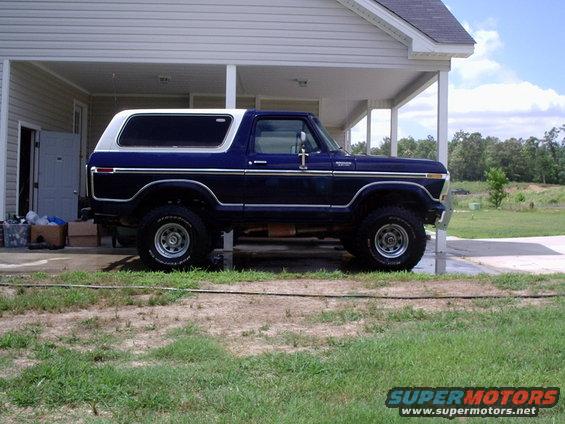 1978 Ford Bronco parked under a covered patio, side view