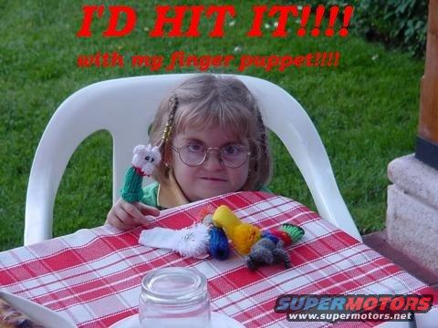 Girl with glasses and pigtails sits at a table with finger puppets