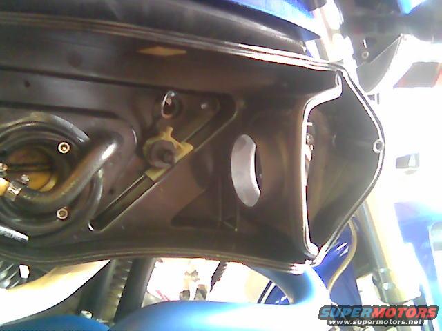 Motorcycle airbox interior with fuel lines and visible Supermotors.net logo