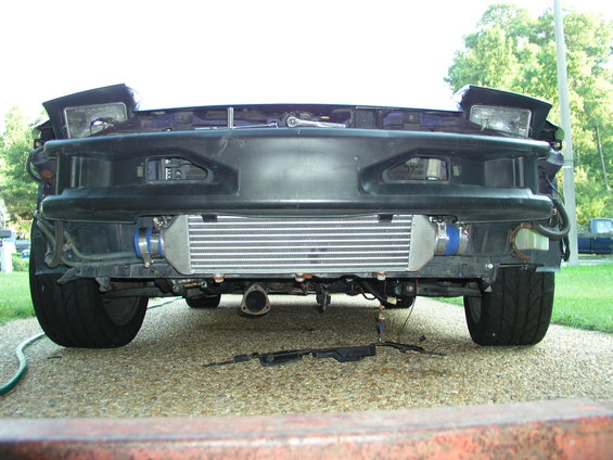 Front mount intercooler installed on a vehicle with pop-up headlights