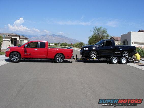 dsc03078a.jpg Truck and trailer.  Trailer weight in the neighborhood of 7,000 lbs with a 2000 Ford lightning on it.  With my Bronco on the same trailer I'm figuring closer to 8,000 lbs.  The Titan had plenty of power for the pull, but I really need to add a prodigy to help with stopping.