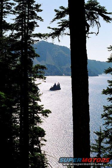 Crater Lake scene with Wizard Island and trees in foreground