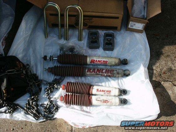Rancho RS 5000 shocks, U-bolts, and lift blocks laid out on a plastic sheet