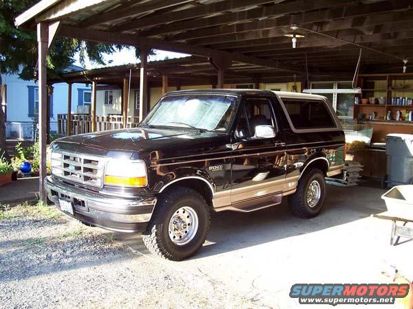 Black 1996 Ford Bronco parked under a carport