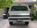 1992 Ford Bronco - Rear view of a white 1992 Ford Bronco parked in a driveway.