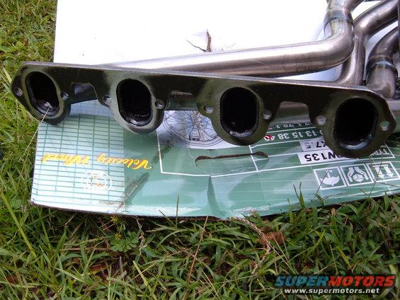 Exhaust headers on a green box with text 'Velocity Wheel' and part numbers