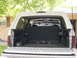 1992 Ford Bronco - The interior cargo space of a white SUV is visible with the tailgate open.