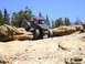 1989 Ford Bronco - This custom buggy navigates a rocky trail under a clear blue sky.