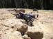 1989 Ford Bronco - Multiple off-road vehicles navigate a rocky terrain during an outdoor event.