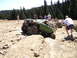 1989 Ford Bronco - A modified 1989 Ford Bronco navigates a challenging rocky terrain with onlookers present.