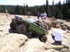 1989 Ford Bronco - A modified 1989 Ford Bronco navigates a challenging rocky trail with spectators watching.