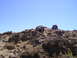 1989 Ford Bronco - Off-road vehicles tackle challenging rocky terrain on a sunny day.