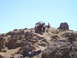 1989 Ford Bronco - Two off-road vehicles navigate a steep, rocky incline on a sunny day.