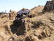 1989 Ford Bronco - A custom off-road buggy navigates a challenging rocky terrain during an outdoor event.