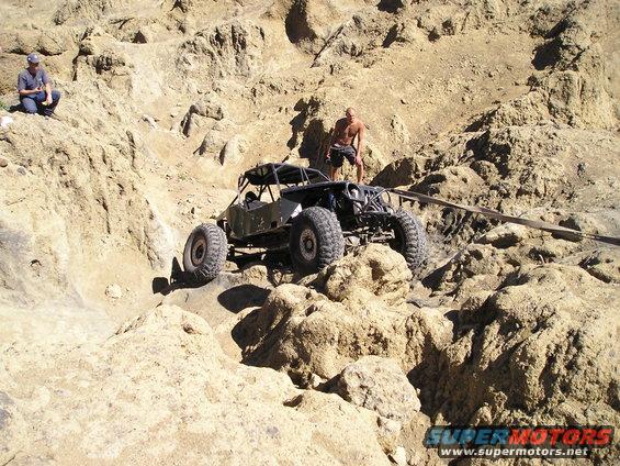 Off-road buggy climbing rocky terrain