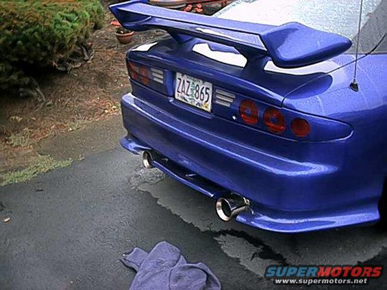 blue sports car's rear end, showing spoiler, custom exhaust tips, and license plate ZAZ 865