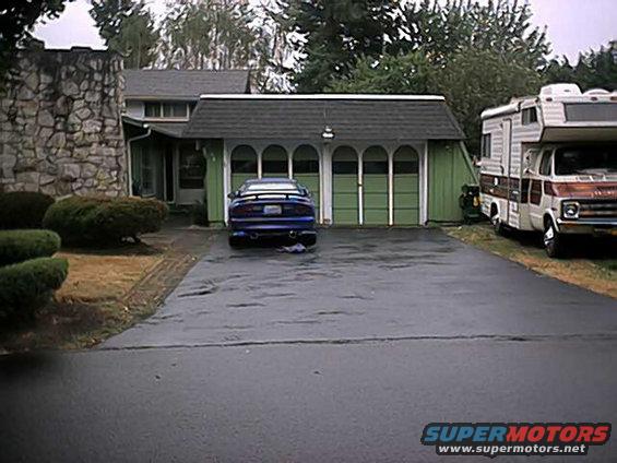 Blue 1993 Ford Probe rear view parked in driveway