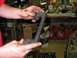 1991 Volkswagen Golf - A person holds a dark-colored automotive part in a cluttered garage setting.