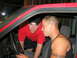 1991 Volkswagen Golf - Two men are inside the cab of a red truck, one looking at the camera and the other looking towards the driver's seat.
