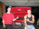 1991 Volkswagen Golf - Two men stand in front of the open engine bay of a red 1991 Volkswagen Golf.
