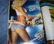 1994 Ford F-150 - A woman poses with a power tool next to a beer advertisement on a magazine page.