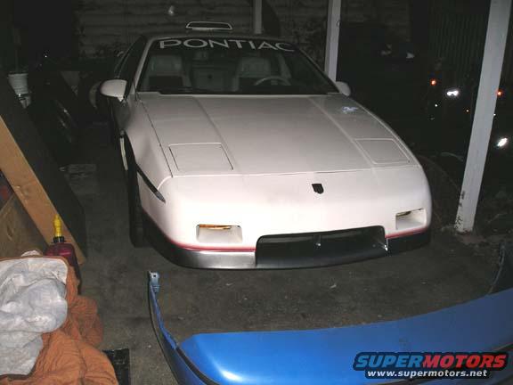 1984 Pontiac Fiero front view in garage. Pontiac lettering on windshield