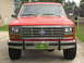 1985 Ford Bronco - Front view of a red Ford truck, likely from the early 1980s, with a prominent grille.