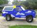 1985 Ford Bronco - This Ford Bronco has been customized with a unique painted design of clouds and a sun.
