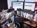 1988 Ford Bronco - A collection of spray paint cans is organized on a desk next to computer monitors and a keyboard.