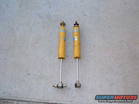Pair of yellow Bilstein shock absorbers with blue labels
