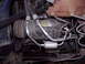 1992 Ford F-150 - Vehicle AC compressor with hoses and filter drier visible in engine bay.
