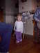 1992 Ford F-150 - A young child stands in a room, with parts of adults visible on the left and right.