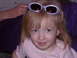 1992 Ford F-150 - A young child is posing for a photo with a pair of sunglasses perched on top of her head.