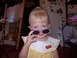 1992 Ford F-150 - A young child with blonde hair and bangs plays dress-up with oversized sunglasses.