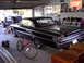 1992 Ford F-150 - A black 1964 Ford Galaxie 500 is parked in a garage next to a red bicycle and a pickup truck.