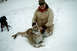 1992 Ford F-150 - A hunter poses with a cougar and his dog in a snowy landscape, with a watermark from SUPERMOTORS.NET visible.