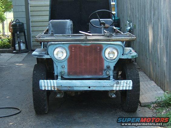 Blue Jeep CJ-3A with red grille, two seats, and a steering wheel, parked outdoors